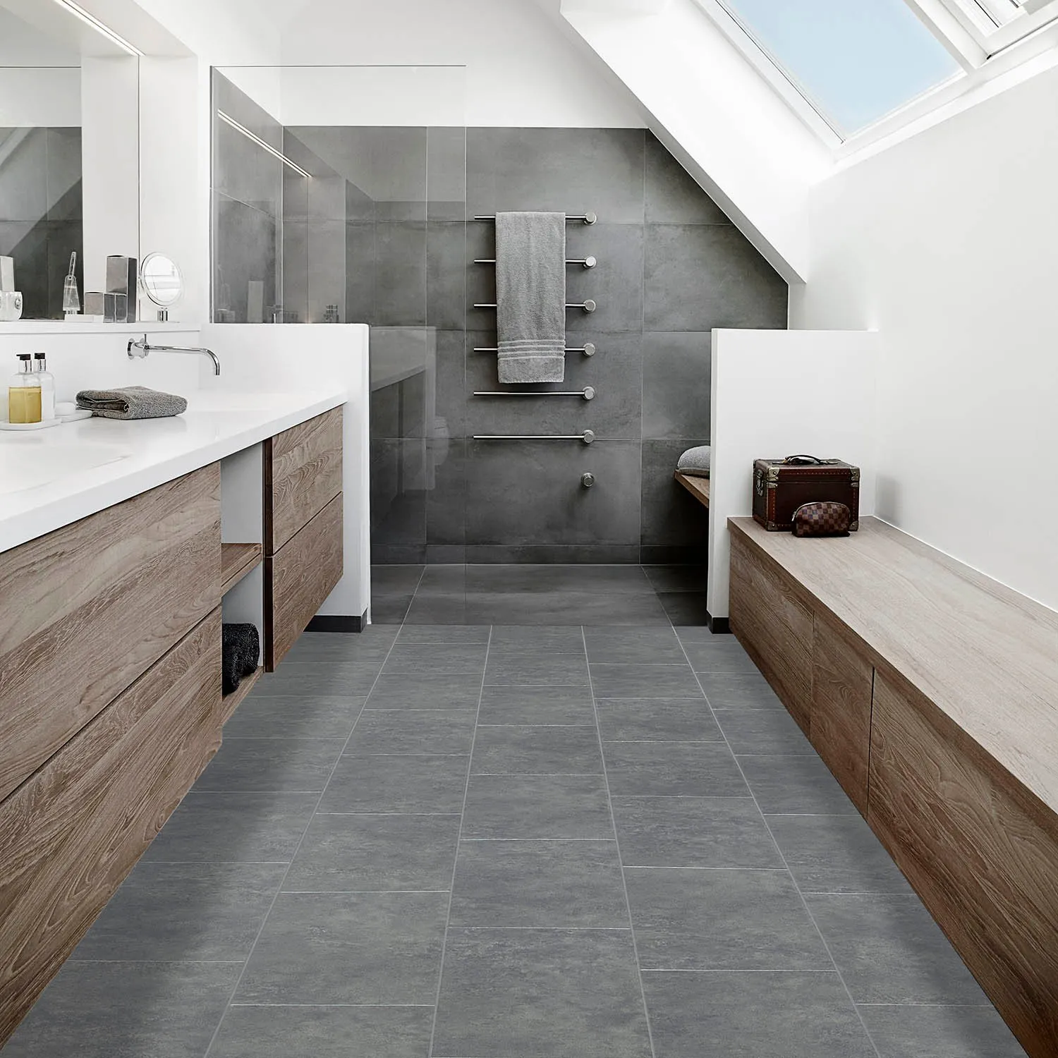 Bright bathroom with modern grey vinyl tile floors and a skylight