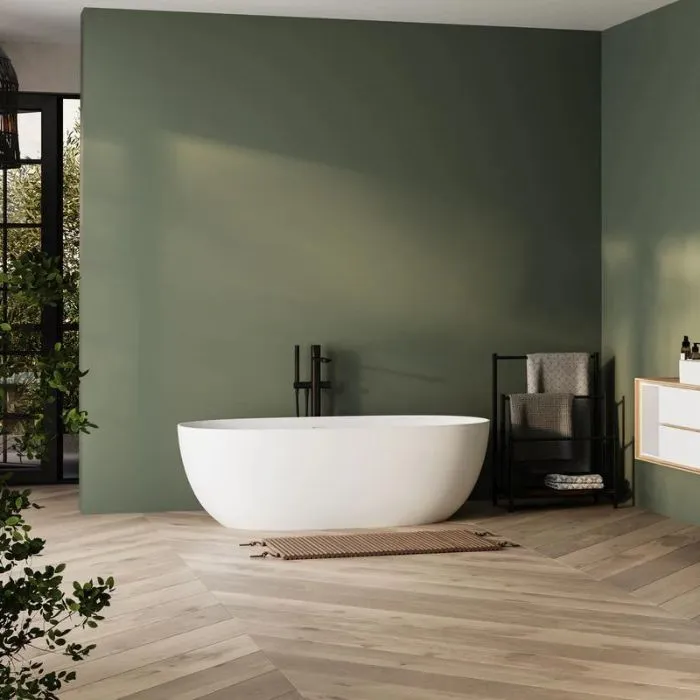 Green-walled bathroom with white bathtub