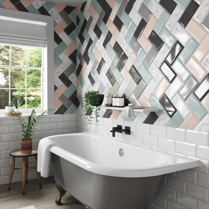 Contemporary bathtub surrounded by colourful metro tiles in a stylish bathroom