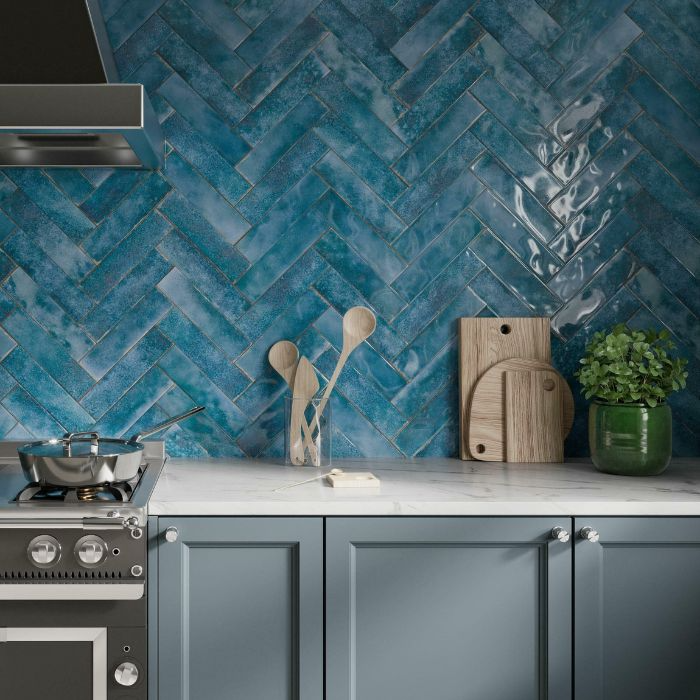 Modern kitchen featuring a striking blue herringbone tile design