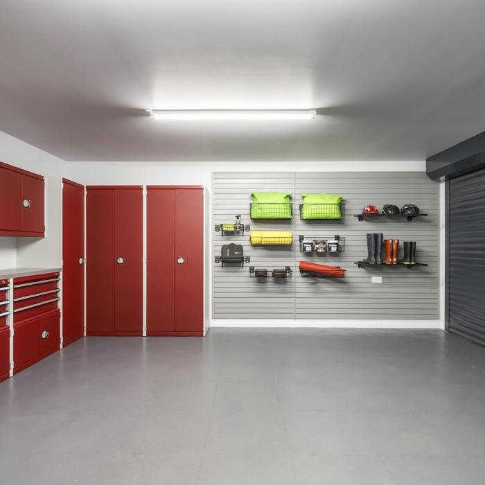 Spacious garage with a red and white theme, featuring a washer and dryer on a well-maintained floor