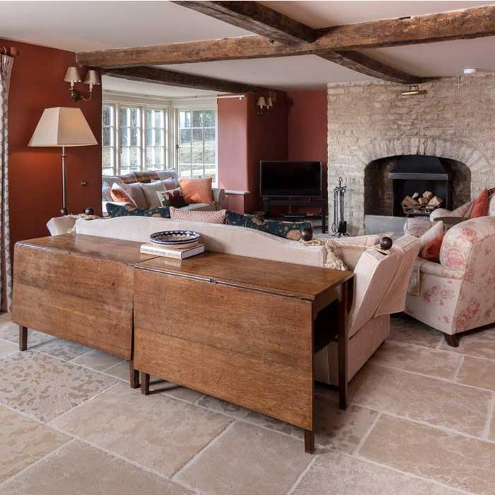 Warm and welcoming living room showcasing a fireplace set against stone floors