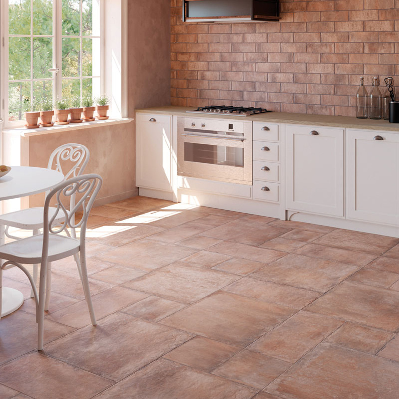 White kitchen table and chairs against terracotta tiles