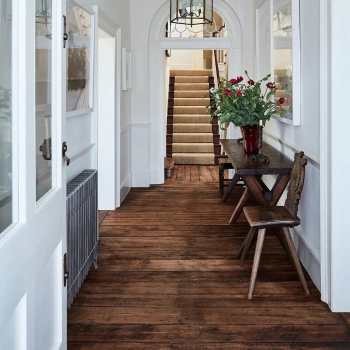 Clean and modern hallway with white walls and warm wooden flooring