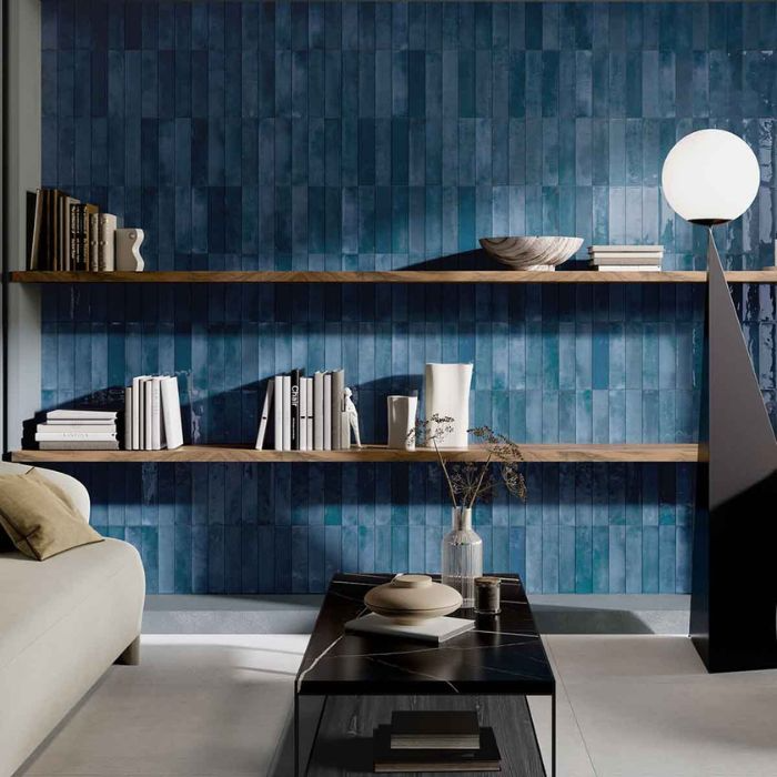 A contemporary living room with striking blue tiled wall