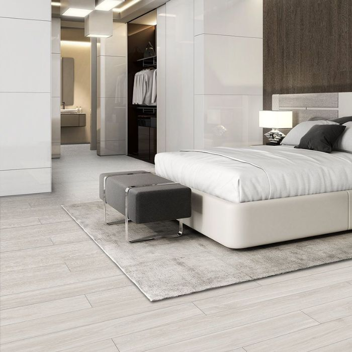 Minimalist bedroom with white walls and elegant wood tile floors