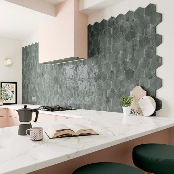 Pink and grey themed kitchen showcasing green hexagon wall tiles