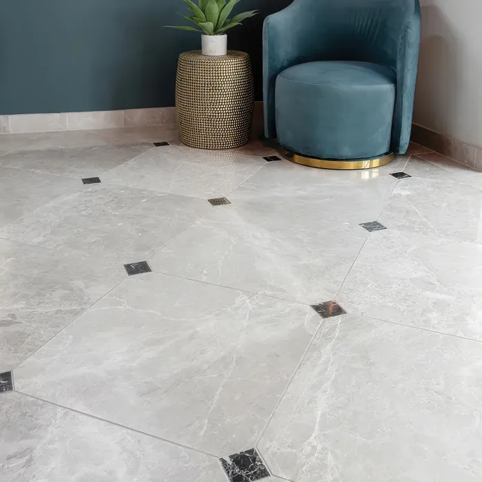 Bright room showcasing glossy white marble tiles alongside a vibrant blue chair