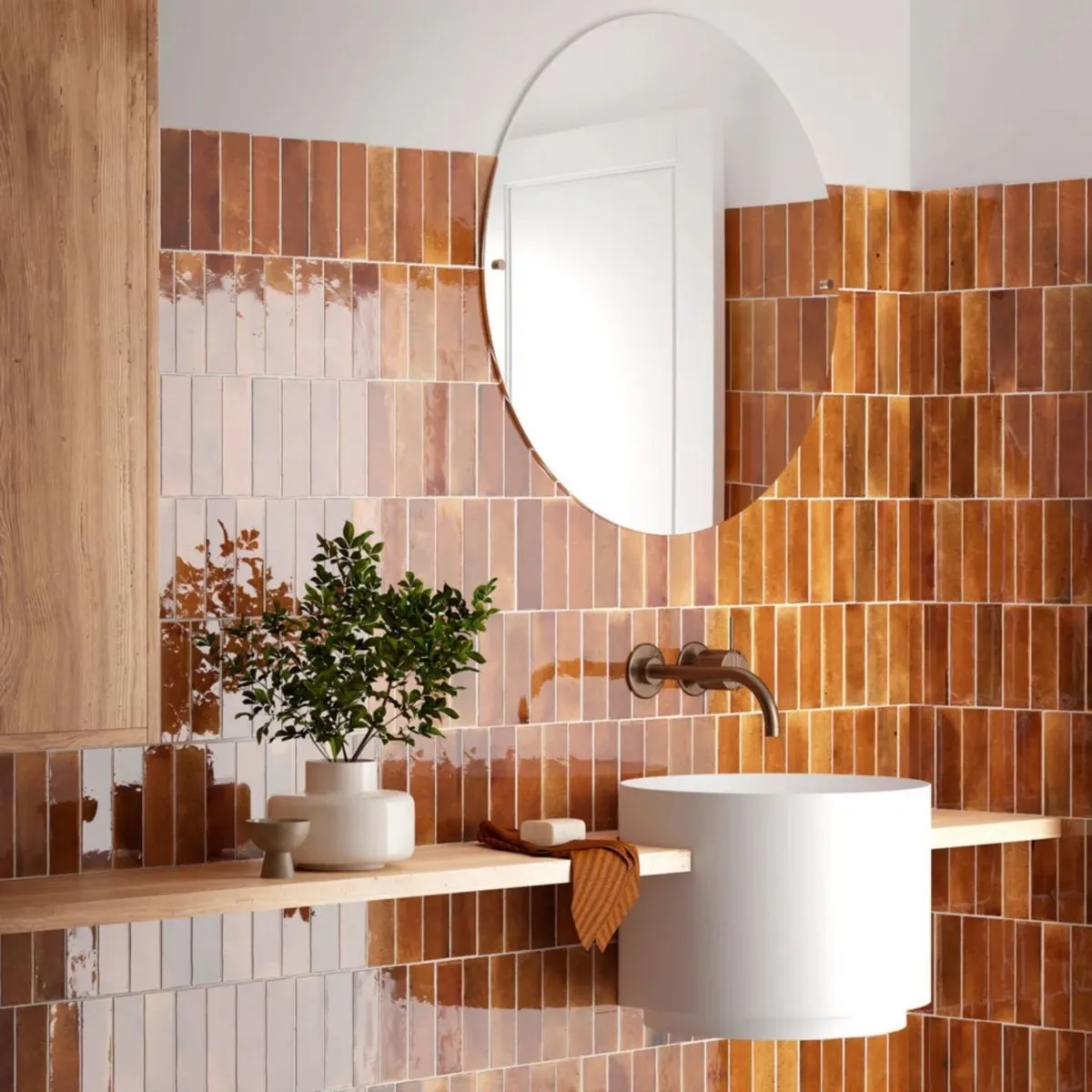 Earthy tones in a bathroom featuring wooden sink and brown tiles