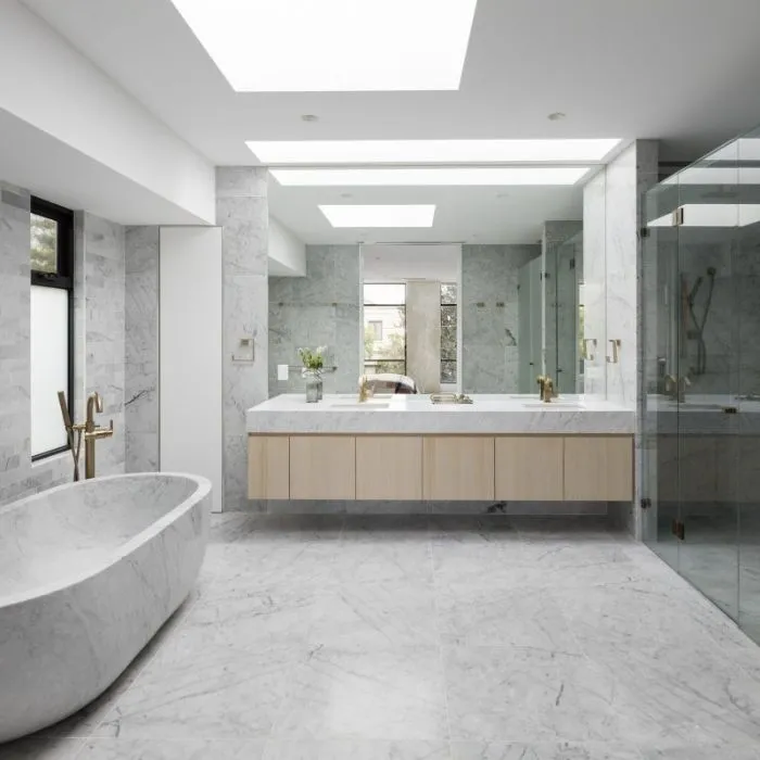 Luxurious modern bathroom with sleek marble floors and a spacious tub