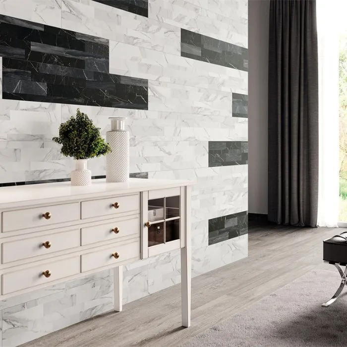 A sleek living room featuring a black and white marble accent wall