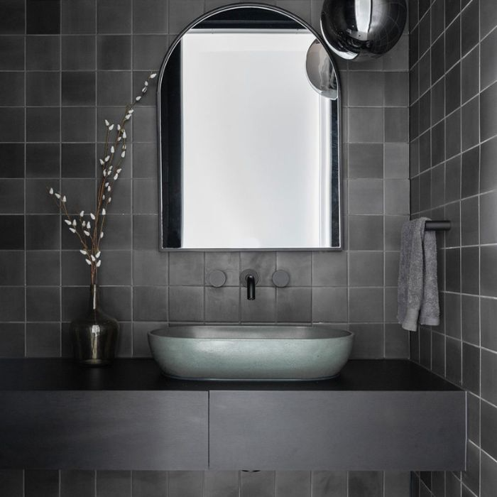 Modern bathroom interior featuring sleek black tiles