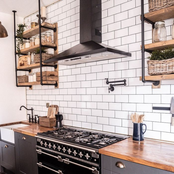 Contemporary kitchen with chic wooden shelves and a stove with a classic white brick splashback