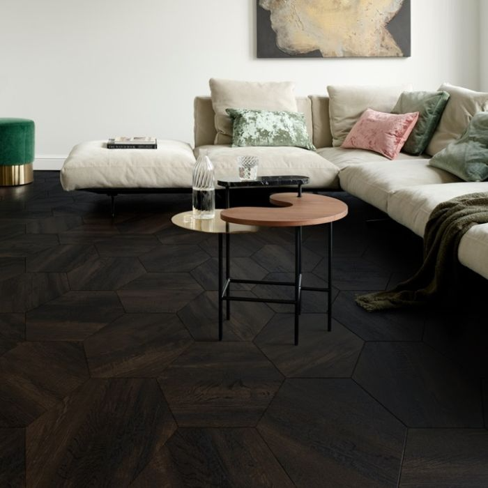 Stylish interior featuring a white couch on black hexagon tiles