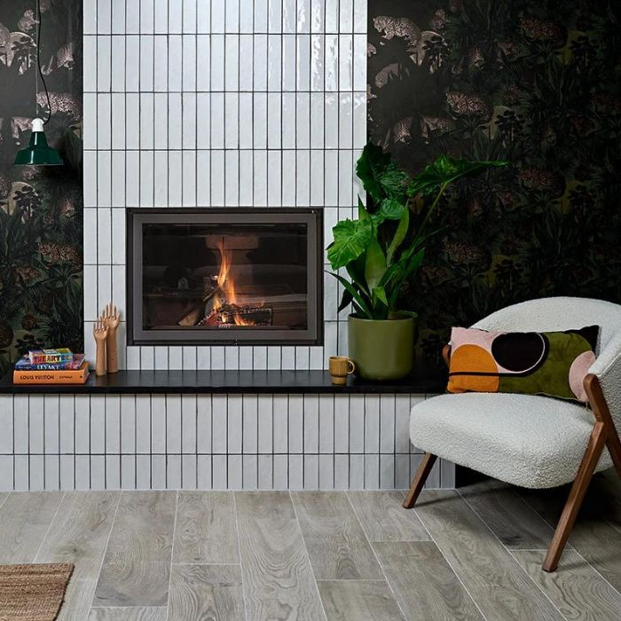 Modern living room with stylish white metro fireplace tiling