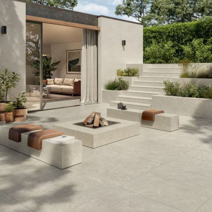 Stylish fire pit on modern outdoor patio tiles