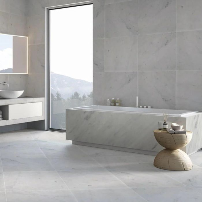 Contemporary bathroom design highlighted by elegant white marble walls and flooring