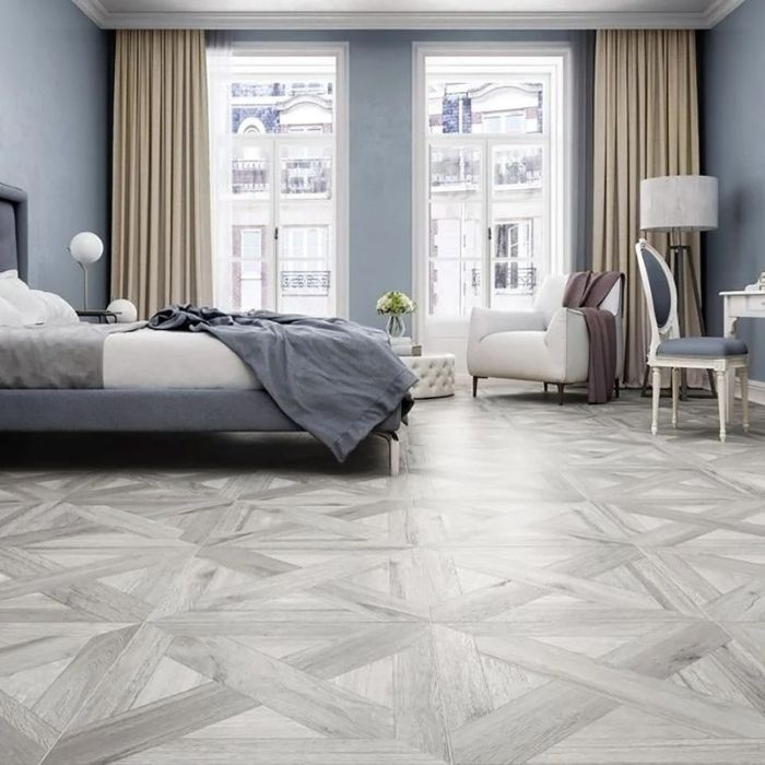 Modern bedroom with a calming blue and white colour scheme, complemented by wooden floorboards 