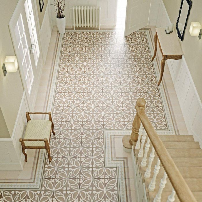 A spacious hallway featuring a decorative tiled floor leading to a staircase