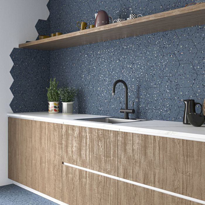 Kitchen with blue hexagon tiles and wooden cabinets