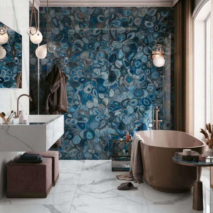 Luxurious bathroom featuring elegant blue marble walls and a bathtub