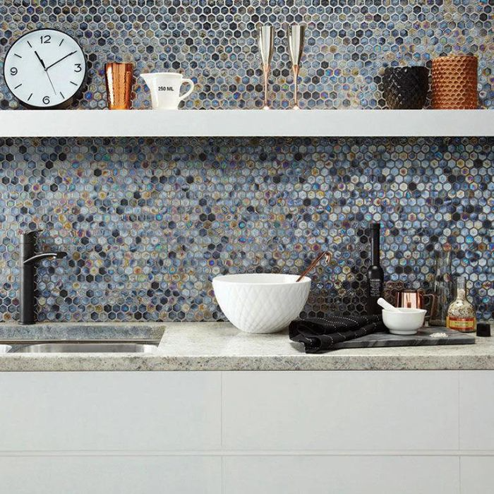 A modern kitchen featuring a vibrant tiled backsplash and a classic wall clock