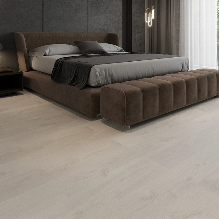 Minimalistic bedroom with luxurious wood flooring and a stylishly presented bed 