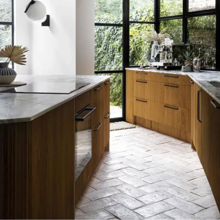 Natural light illuminating a charming kitchen space with terracotta flooring