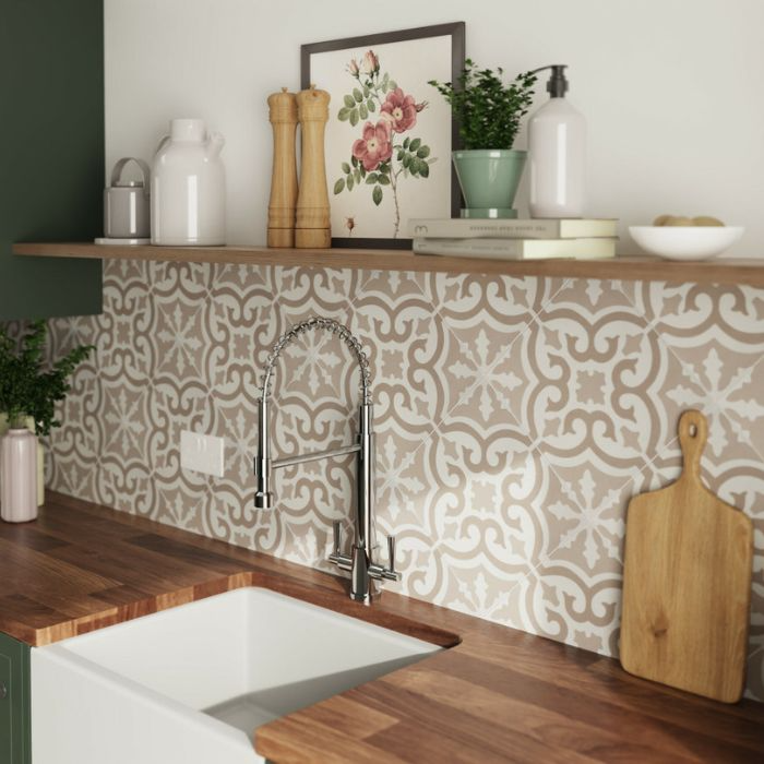 Stylish kitchen sink with intricate tiled backsplash