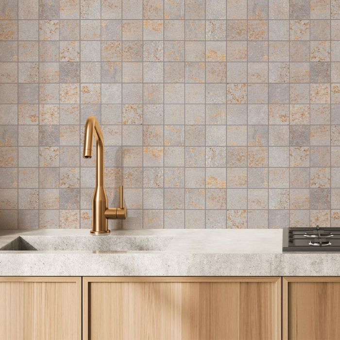 Inviting kitchen space featuring a sleek wooden countertop alongside a stunning array of mosaic tiles