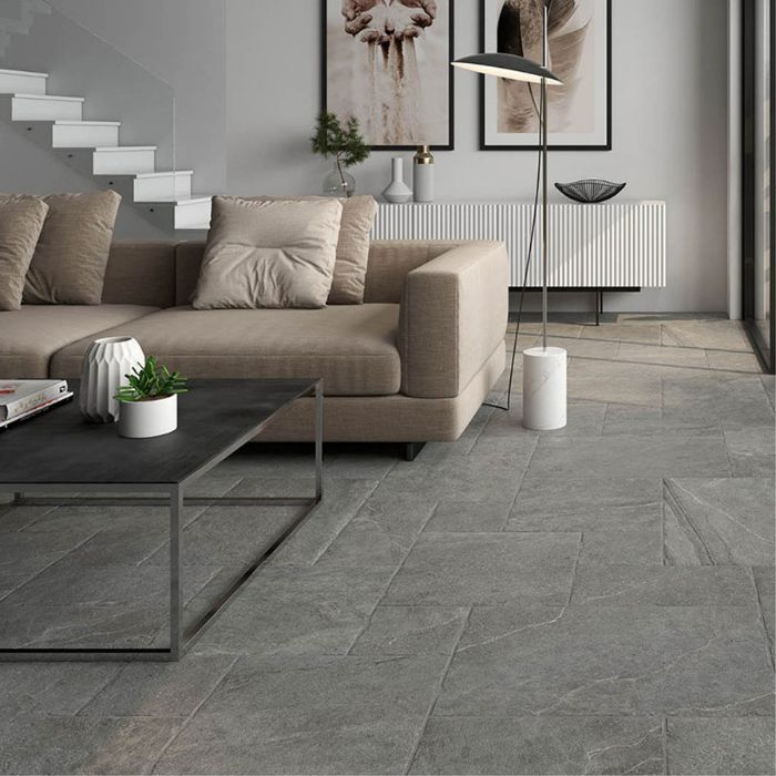 Stylish interior with sleek grey floor tiles, a comfortable couch, and a chic coffee table