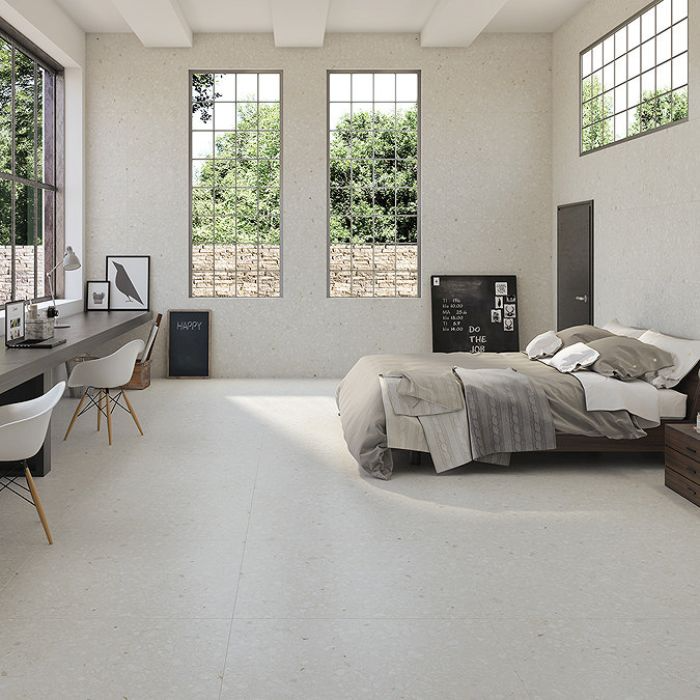 Bright and airy white bedroom with spacious windows and large-format white terrazzo effect tiles