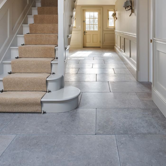 An elegant hallway showcasing stone-effect floor tiles