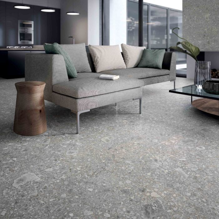 A living room featuring a grey couch and a coffee table on elegant vinyl flooring 