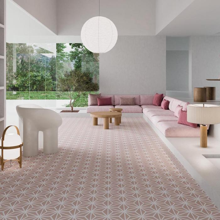 A lounge room featuring pink and white furniture, complemented by a warm, wooden floor