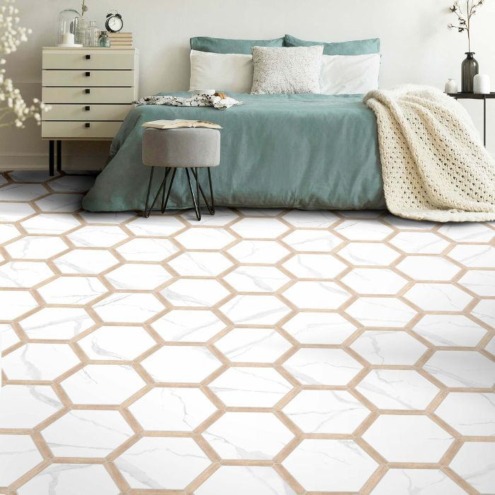 A bright and airy bedroom with a sophisticated hexagonal tile design in white and gold