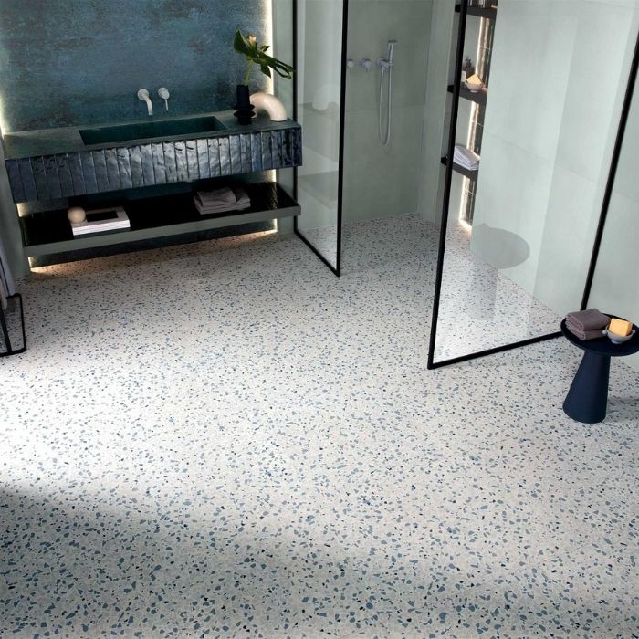 A bathroom adorned with a beautiful blue and white tile floor, enhancing its overall appeal 