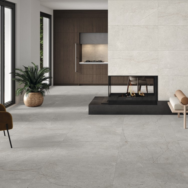 Bright living room featuring large grey concrete-effect floor tiles and a central fireplace