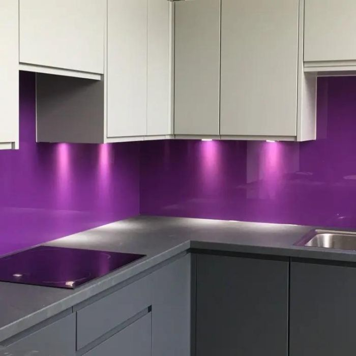 Eye-catching purple splashback in stylish kitchen