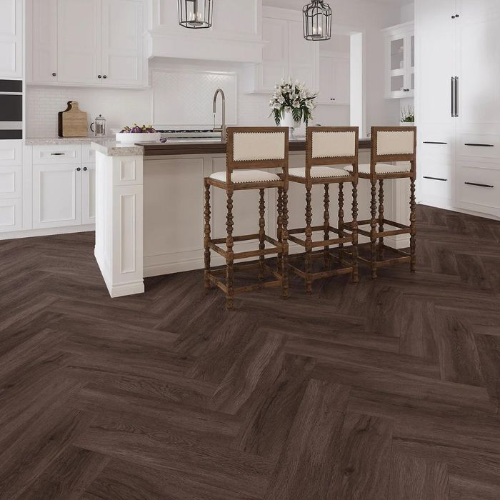 White cabinets contrasting with dark herringbone kitchen floor