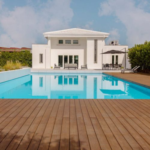 Luxurious white house with wooden deck and swimming pool