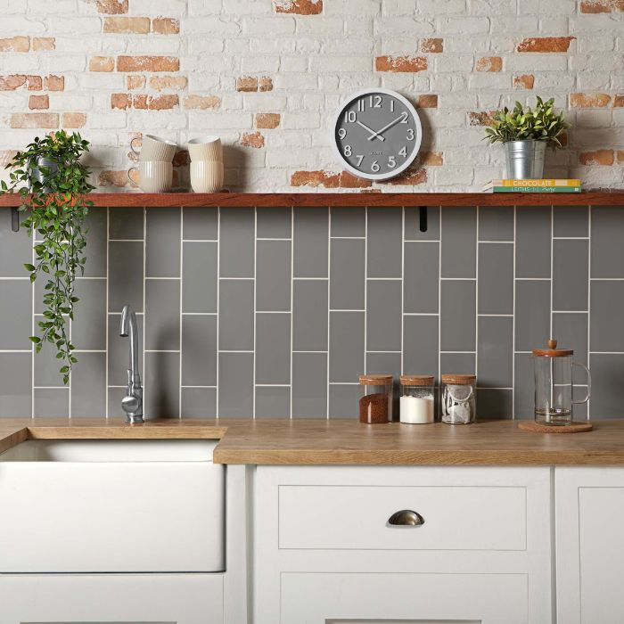 Serene kitchen environment showcasing a sink against subway tiled brick walls