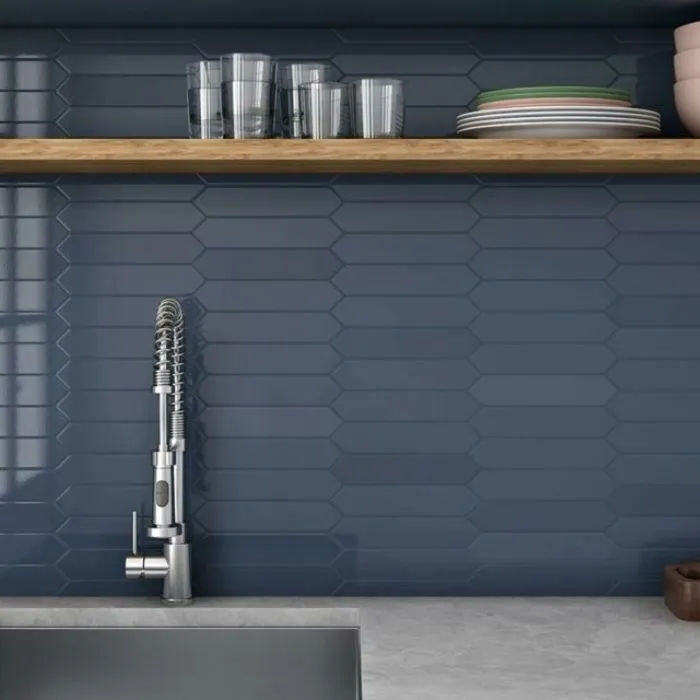 A serene blue kitchen with charming arrow tiles