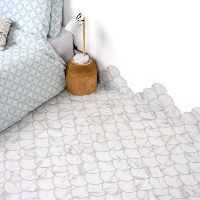 Bright bedroom with a welcoming bed, minimalist bedside table, and fish scale-style flooring 