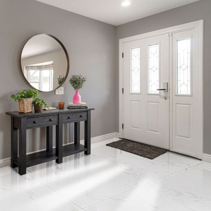 Stylish black and white entry featuring mirror and table