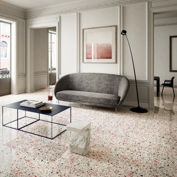 Living room with grey sofa and terrazzo floor tiles in cream and pink tones