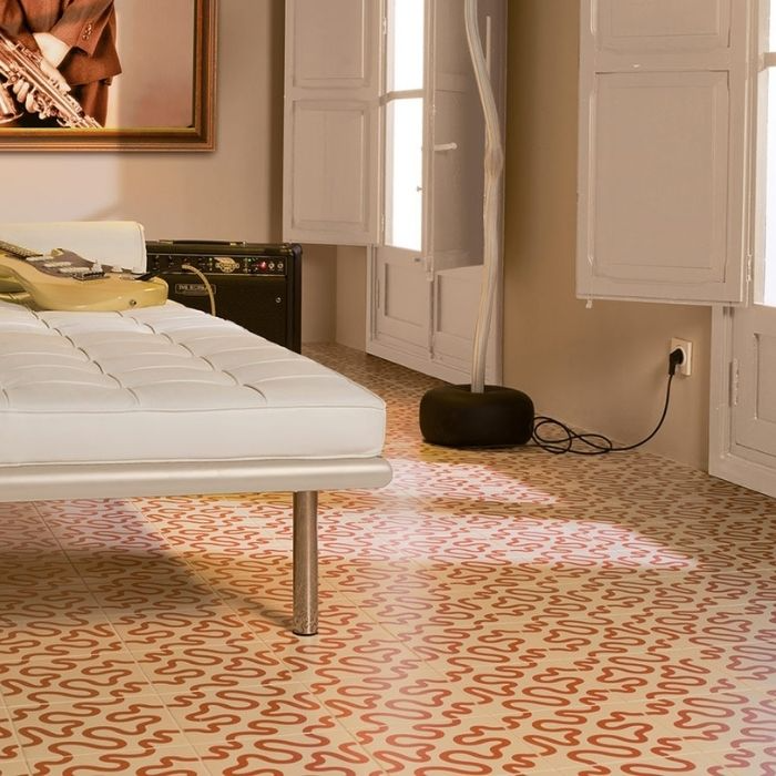 Bright white bedding contrasts beautifully with intricate tile patterns on the floor 