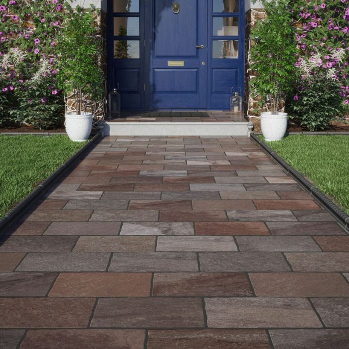 A picturesque pathway to a house with a striking blue entrance