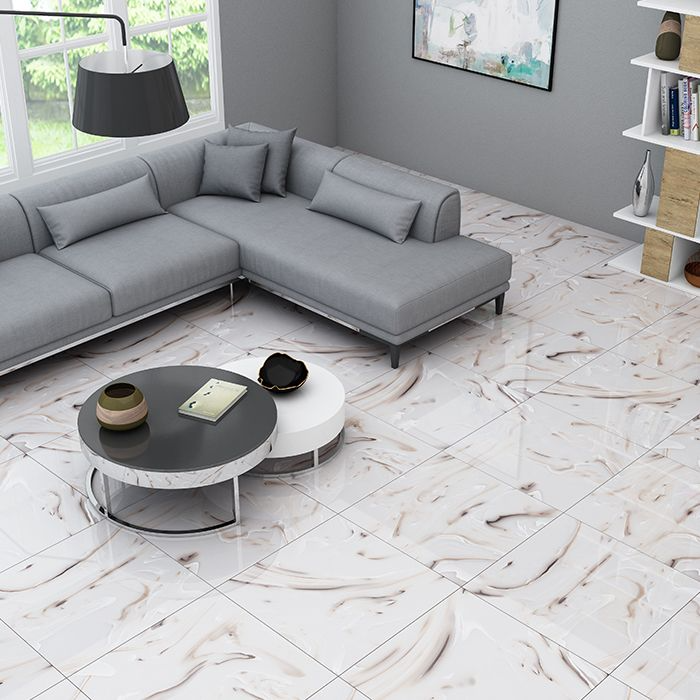 White sofa and coffee table in a living room with stylish marble floor tiles