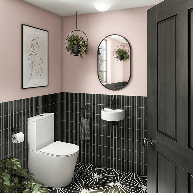 Pink-walled bathroom with striking black tiles